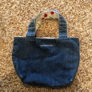 Aéropostale mini jean purse lined with light blue and cherry patteren.